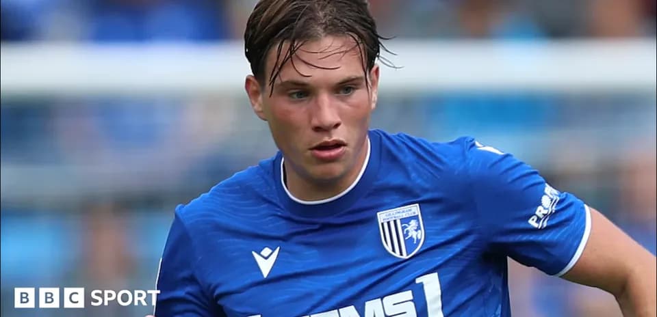 Player in blue kit running on the field