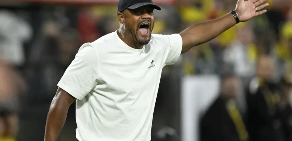 Coach gesturing passionately on the sidelines