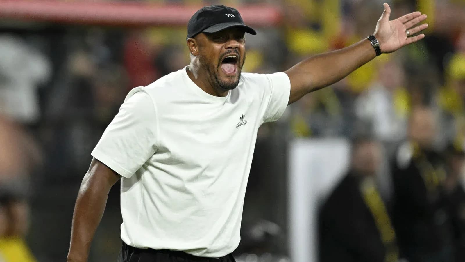 Coach gesturing passionately on the sidelines