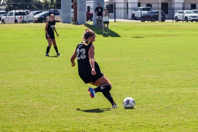 Player wearing number 23 kicking a soccer ball