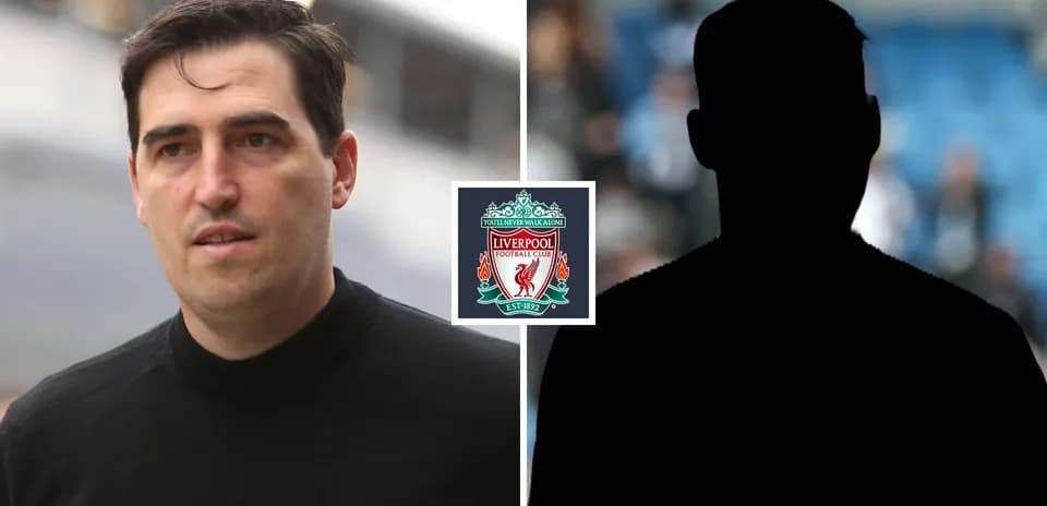 Person walking near Liverpool FC logo backdrop