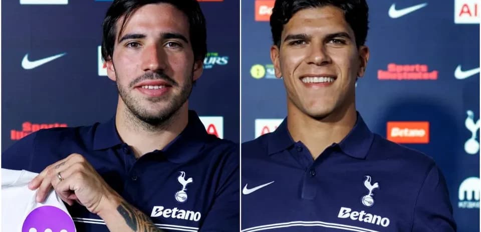 Two players holding jerseys at press conference