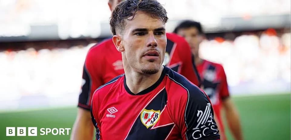 Player in Rayo Vallecano kit on the pitch