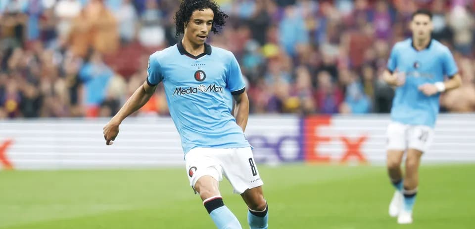 Player in blue kit passing the ball on field