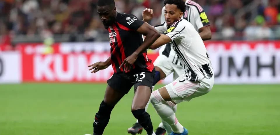 AC Milan and Juventus players battling for possession