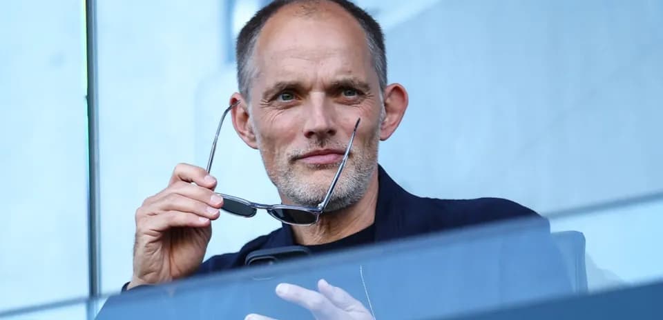Man holding glasses while looking at phone