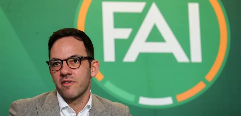 Person speaking in front of FAI logo backdrop