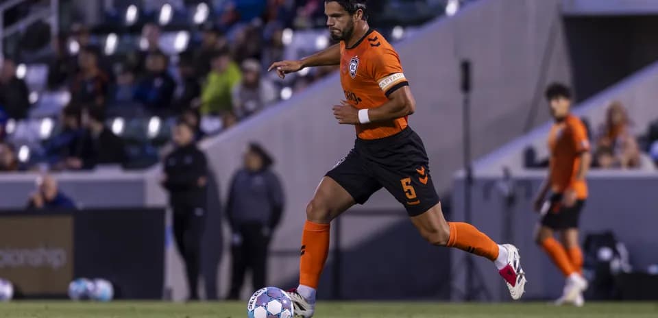 Player dribbling ball during New Mexico United match