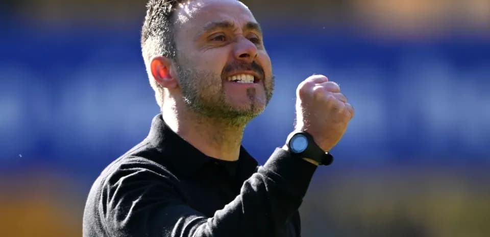 Coach celebrating with clenched fist on sidelines