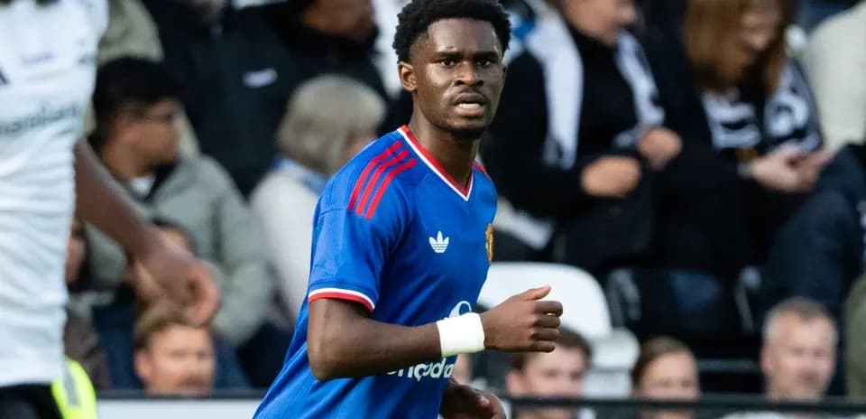 Player in blue kit running on the pitch