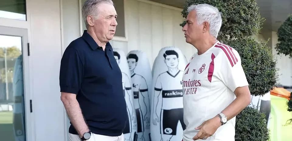Two coaches talking outside training facility