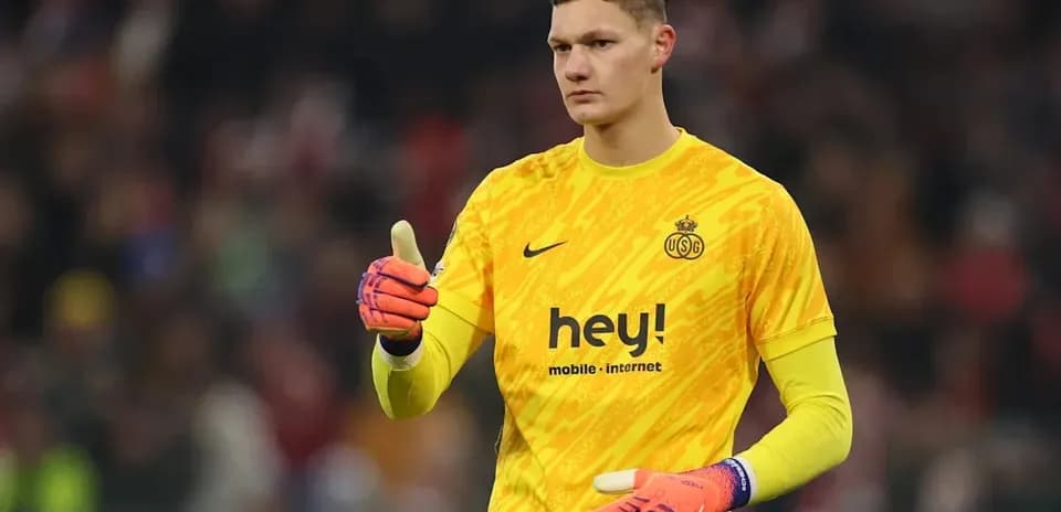 Goalkeeper in yellow uniform giving a thumbs up
