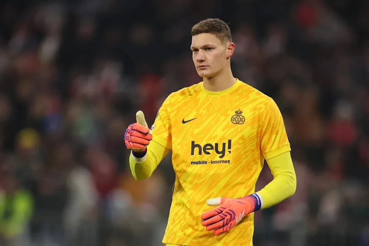 Goalkeeper in yellow uniform giving a thumbs up