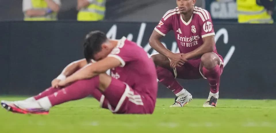 Real Madrid players sitting on the pitch after match