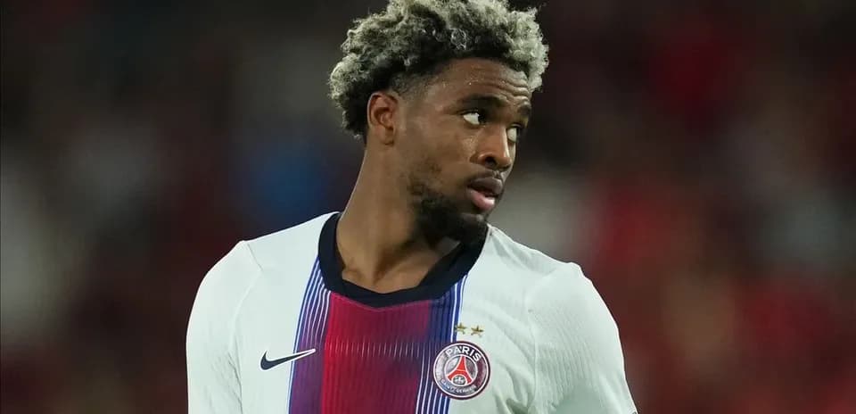 Player in PSG jersey looking away on field