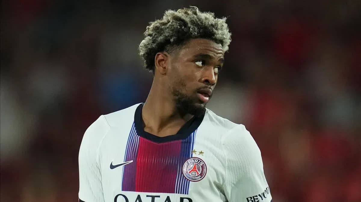Player in PSG jersey looking away on field