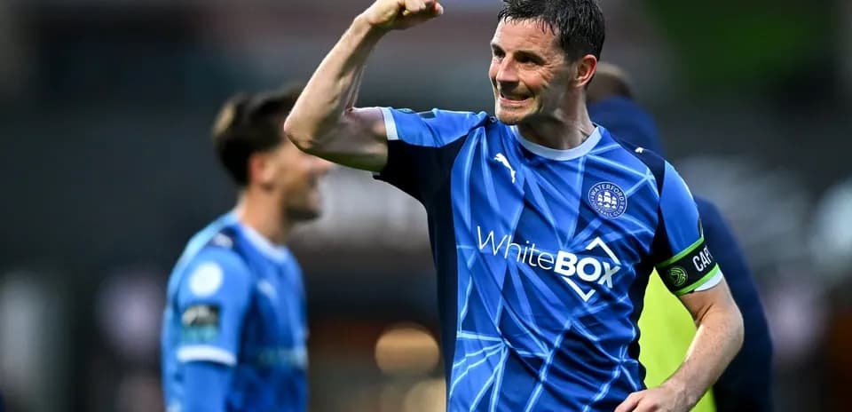Player celebrating victory in blue football kit