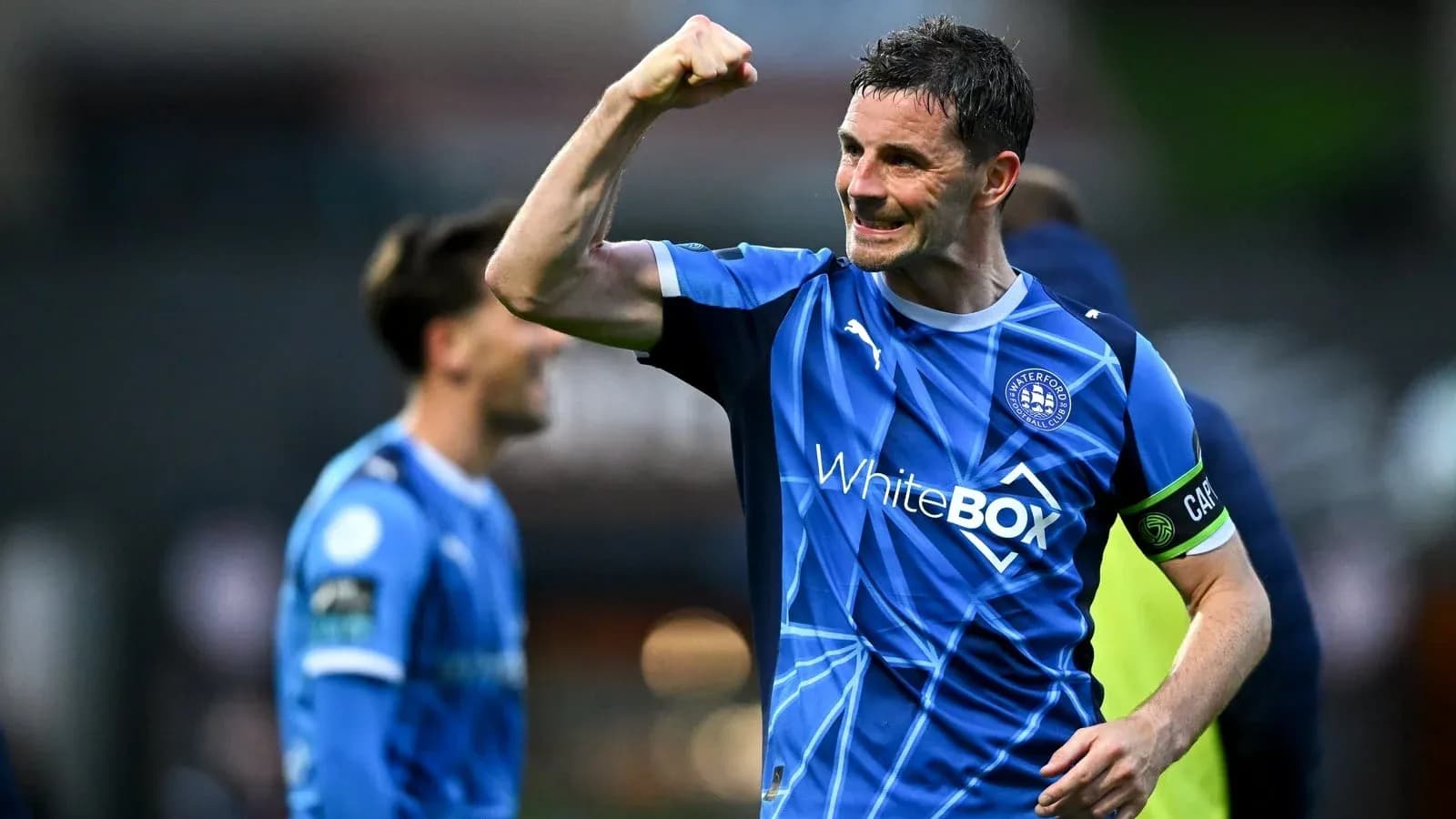 Player celebrating victory in blue football kit