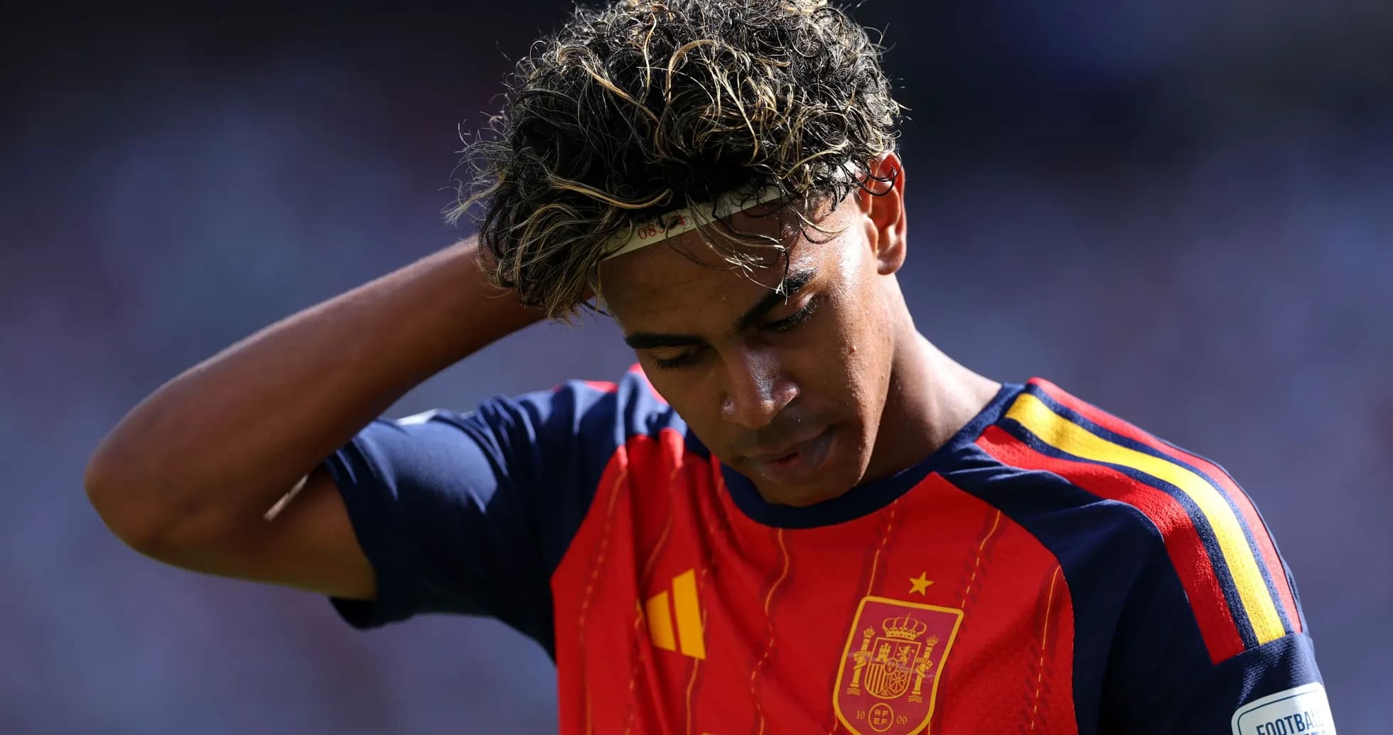 Player in Spain jersey looking down on the field