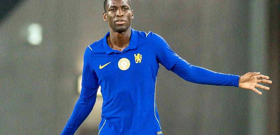 Player in blue jersey gesturing during training session