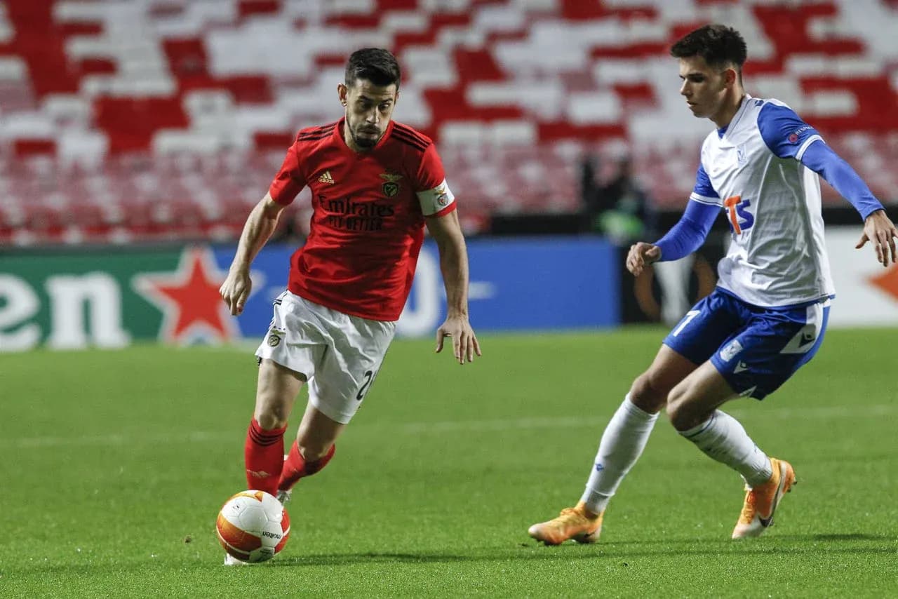 Benfica player dribbling against Lech Poznan Benfica player dribbling against Lech Poznan