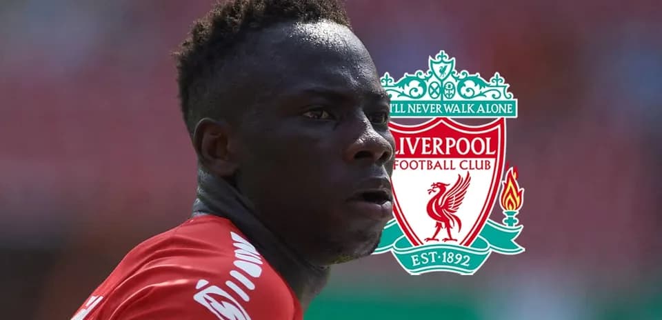 Player in red jersey with Liverpool FC logo background