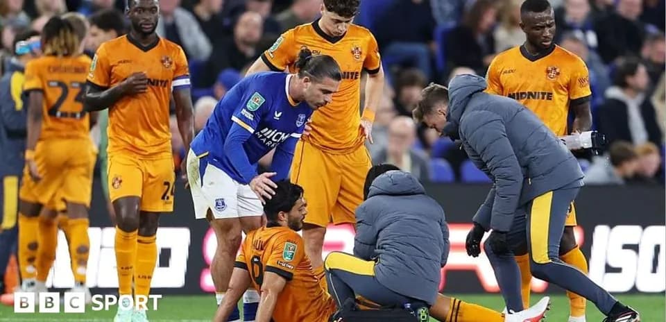 Players attending to an injured teammate on field