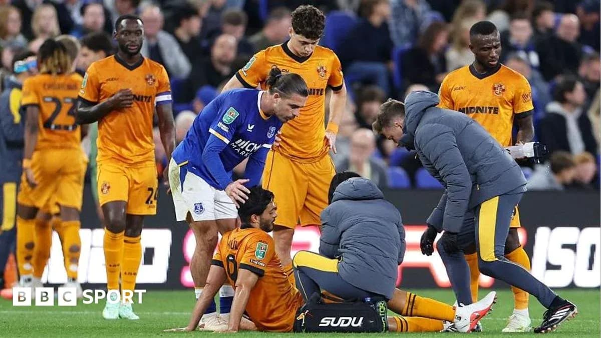 Players attending to an injured teammate on field