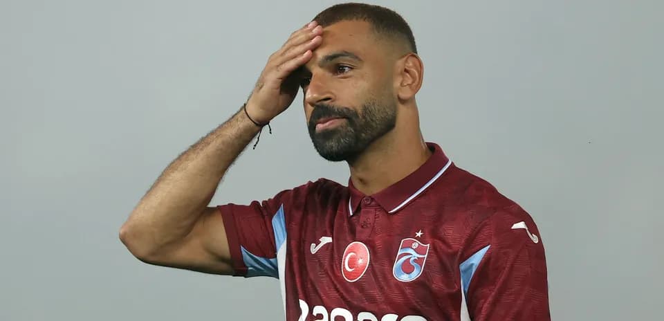 Player wearing maroon jersey at press event