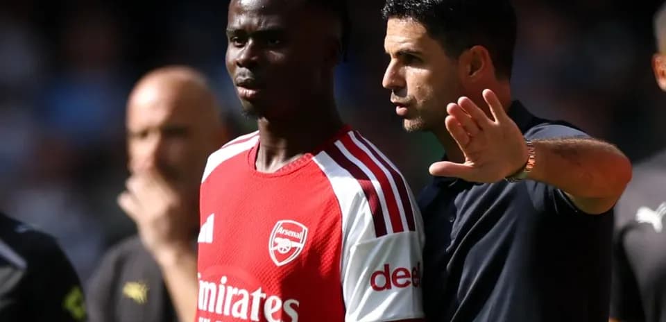 Manager discussing tactics with player during match