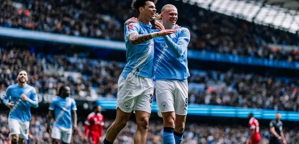 Two Manchester City players celebrating a goal