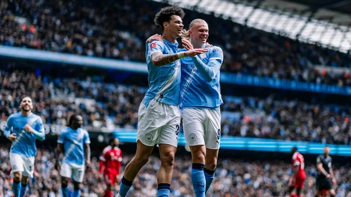 Two Manchester City players celebrating a goal