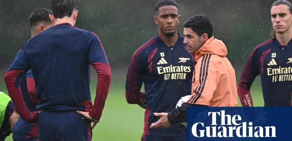 Manager discussing tactics with players during training