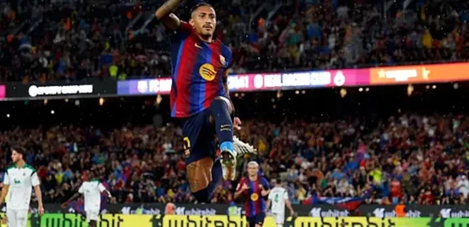 Player celebrating a goal at Camp Nou stadium