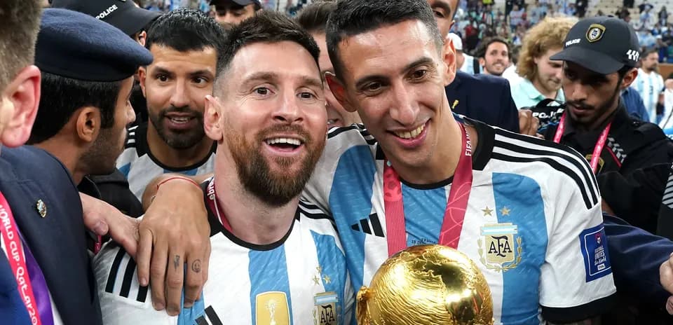 Messi and Di María celebrating with FIFA World Cup trophy