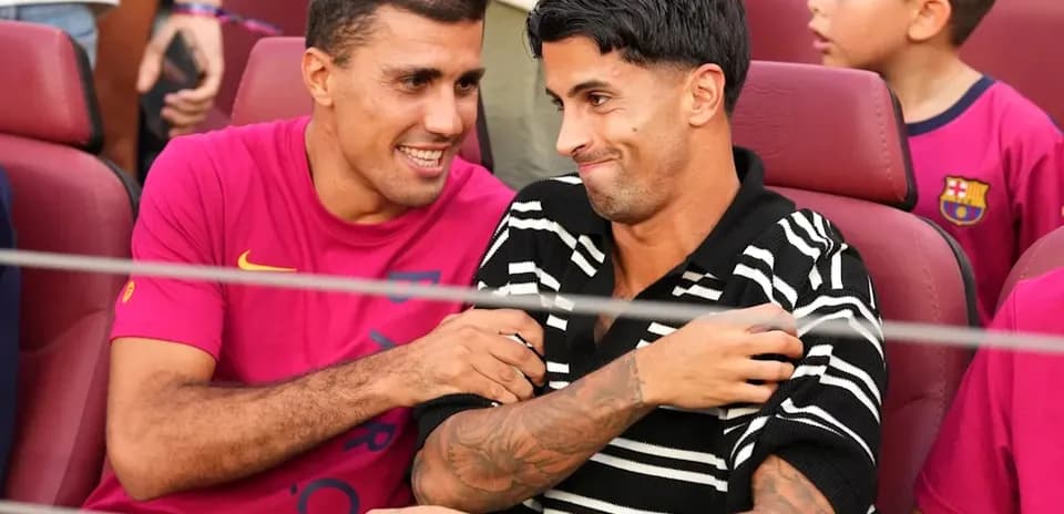 Two players sitting together at a stadium