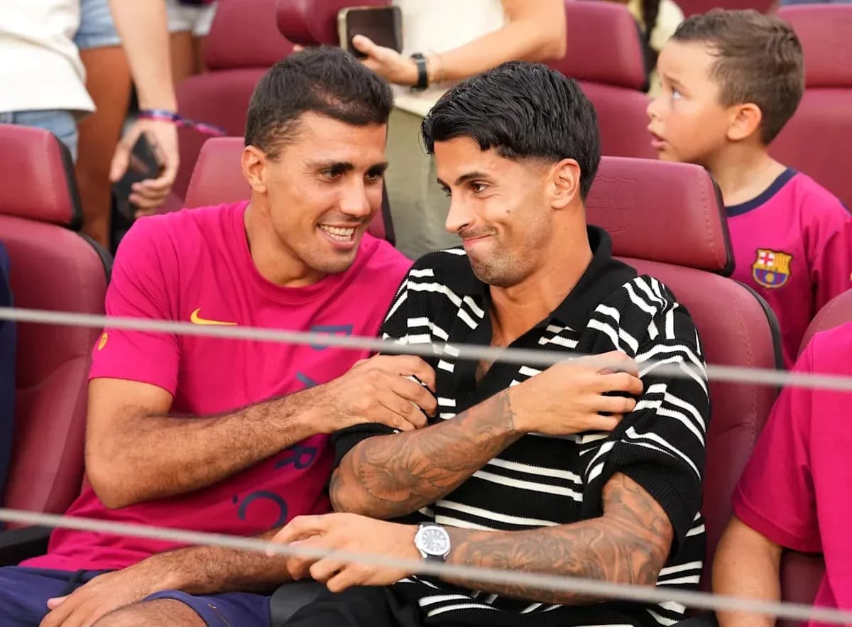 Two players sitting together at a stadium