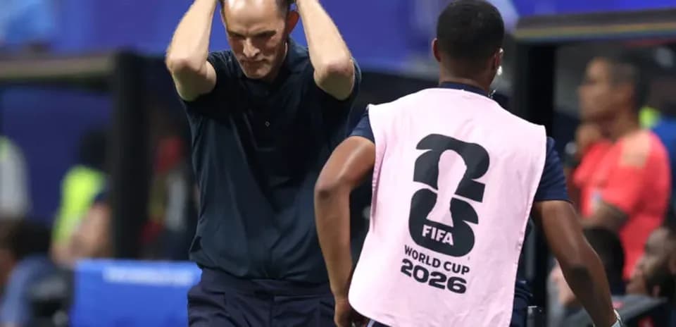 Coach with hands on head during tense moment