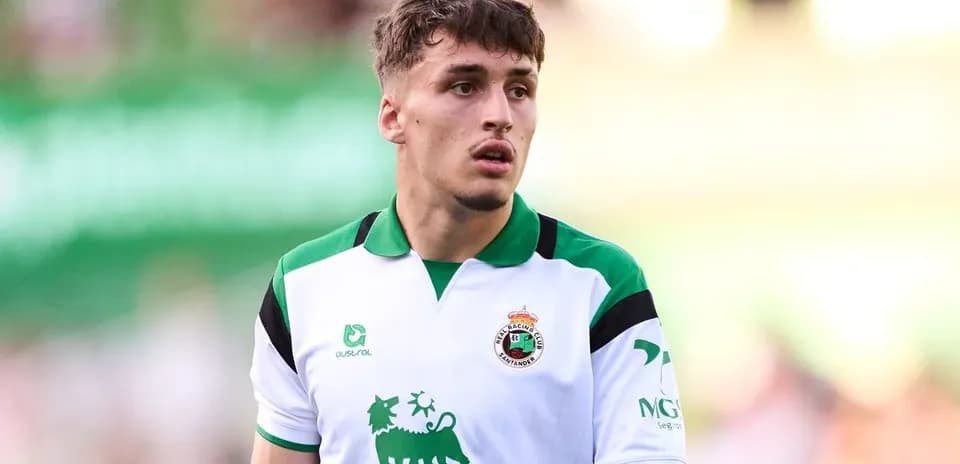 Player in white and green jersey during match
