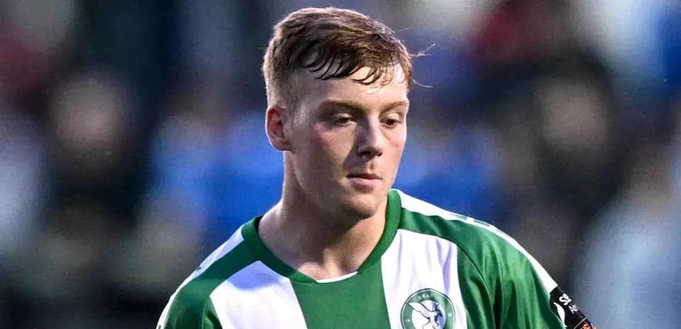 Player in green and white jersey on the field