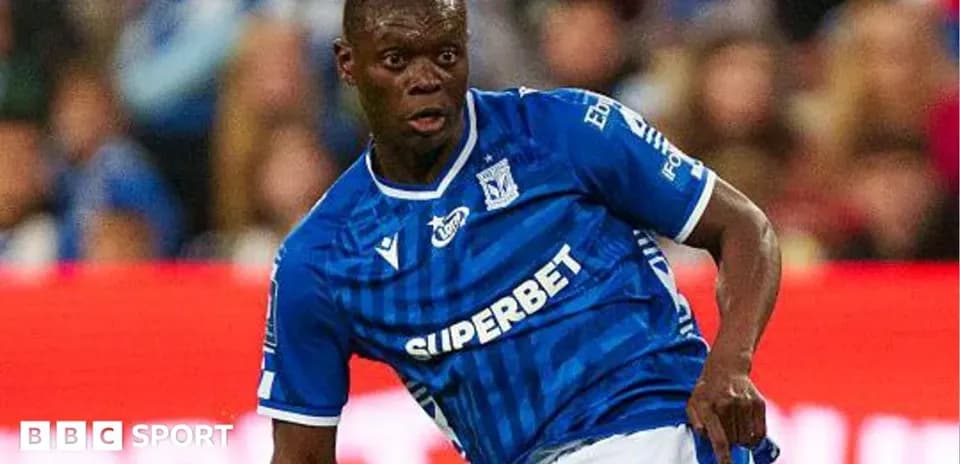 Player in blue jersey dribbling the ball during match