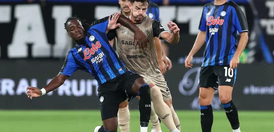 Atalanta player tackling Cagliari opponent during match