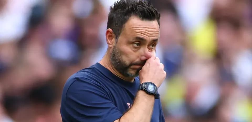 Coach observing the match with concern on sidelines