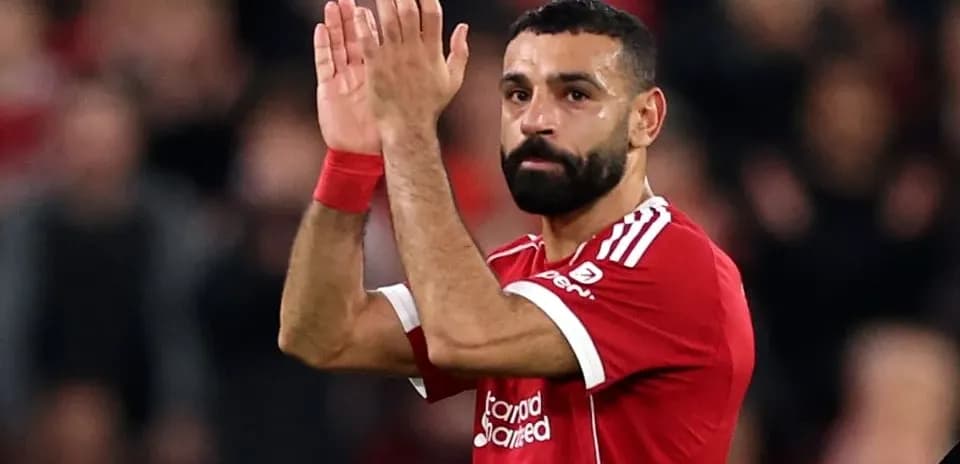 Player applauding fans in Liverpool jersey