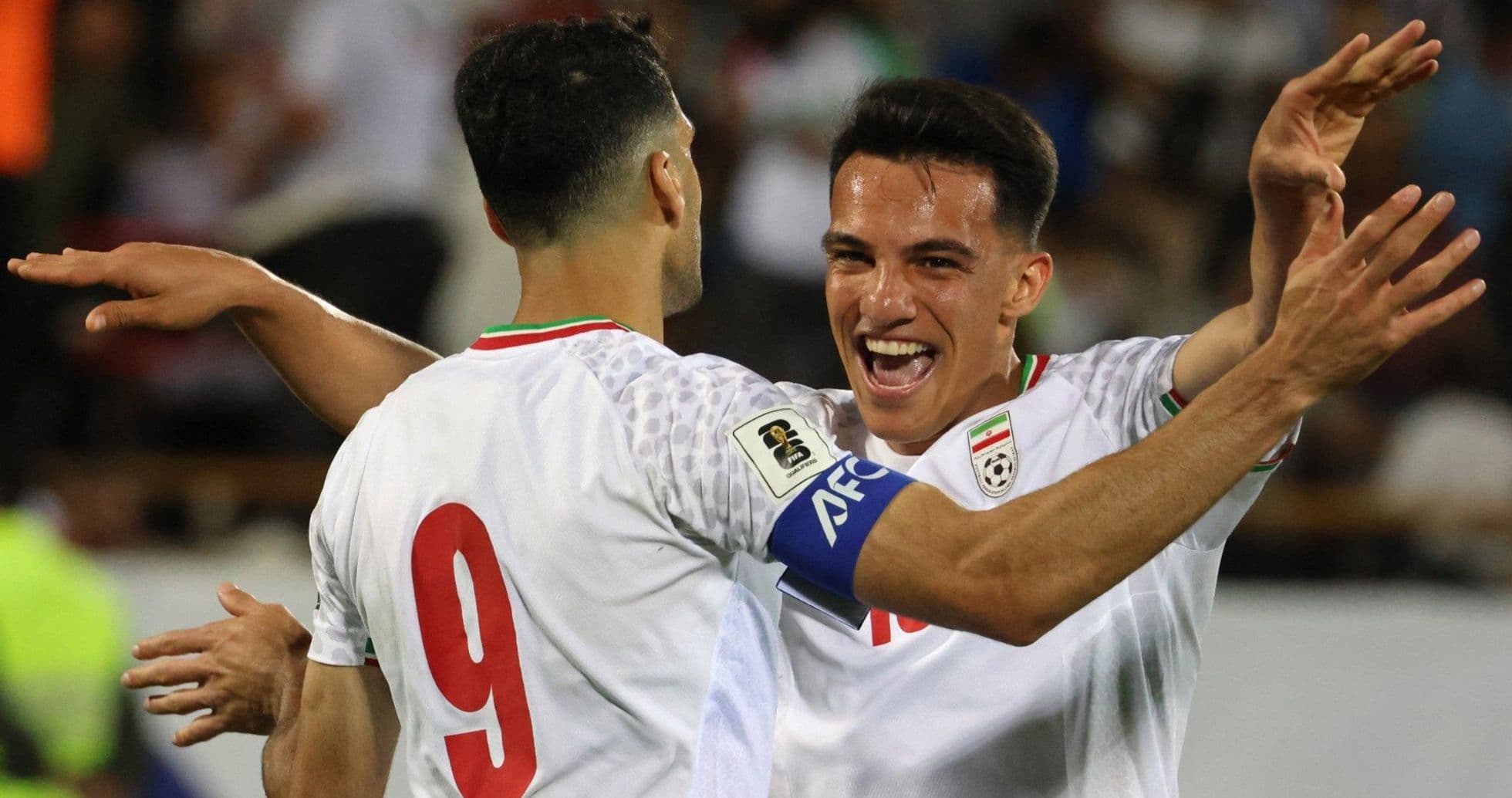 Two players celebrating a goal on the field
