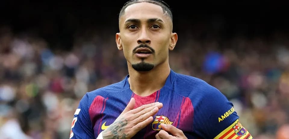 Player touching club badge during match celebration