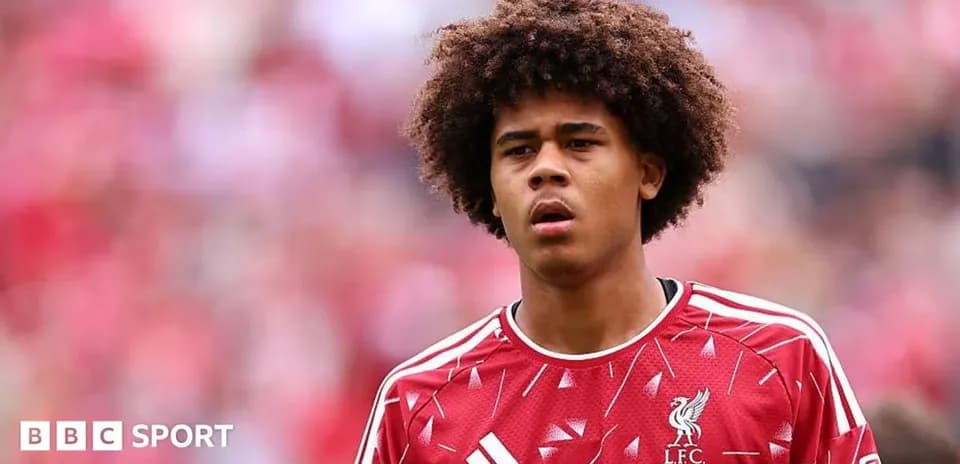 Player in Liverpool kit during match warm-up