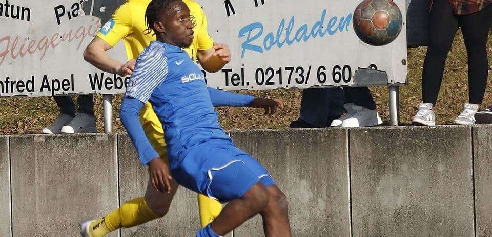 Two players competing for the ball in football match