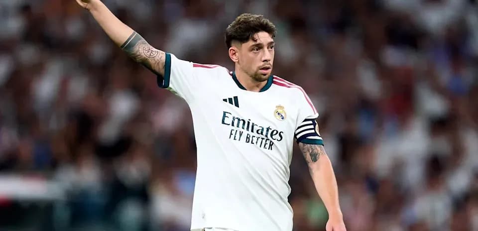 Player gesturing during match wearing Real Madrid kit