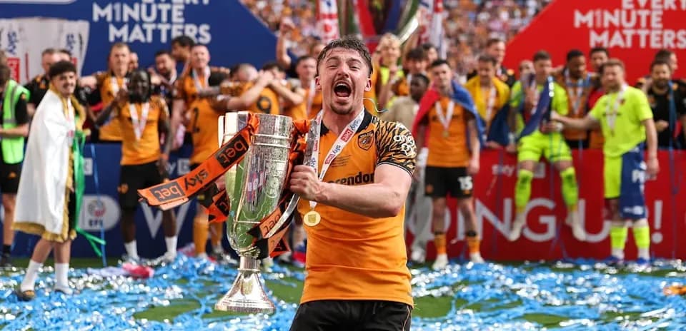 Player celebrating with trophy on victory podium